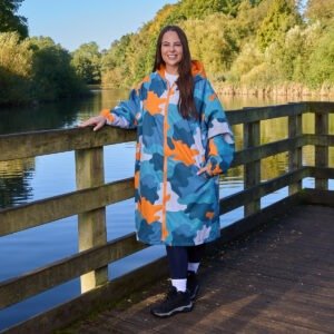 OHS Adults Water Resistant Camo Sherpa Drying Robe in blue and orange from Online Home Shop shown outdoors by the lake