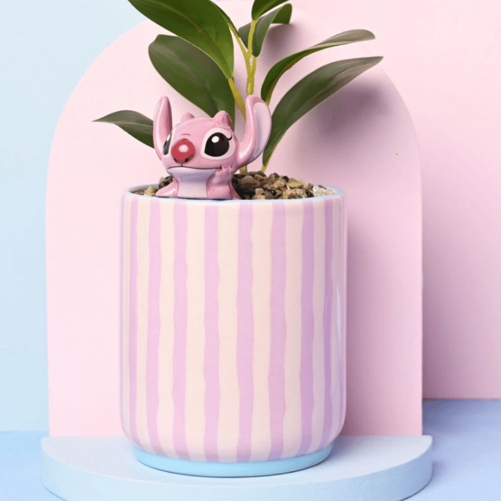 Disney Angel planter with pink striped ceramic pot, 3D Angel character and faux plant