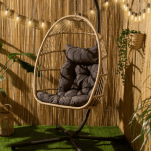 Foldable Hanging Egg Chair in natural finish from OHS with dark cushion and steel stand in garden setting