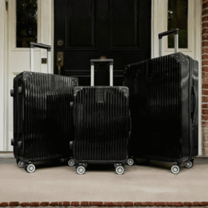 Black hard shell suitcase set with four wheels and telescopic handles in three sizes for travel