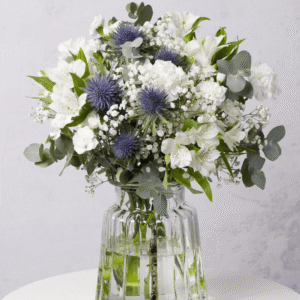 Blue Moon from Bunches showing white flowers with a blue thistle and eucalyptus