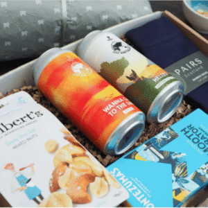 The For Him Package from DBHF showing a gift box with beer, socks, chocolate and snack items