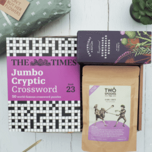 Crossword Gift Box from Don't Buy Her Flowers showing a crossword-themed gift box with tea and biscuits