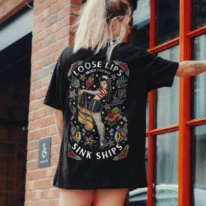 Model wearing the black Loose Lips Sink Ships T-Shirt from Broken Society featuring a large tattoo-inspired back print