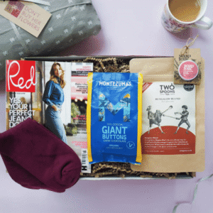The Care Package from Don't Buy Her Flowers showing a care hamper with bamboo socks, lip balm, tea, chocolate buttons and a magazine
