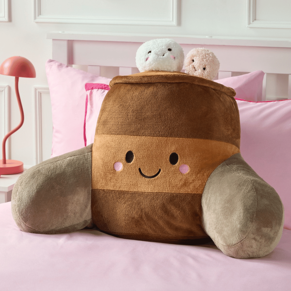 OHS Hot Chocolate brown character cuddle cushion on a bed